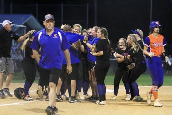 Branford's softball team celebrates winning the Region 3-1A championship after defeating Taylor County 14-3 in five innings on Tuesday night. (PAUL BUCHANAN/Special to the Reporter)