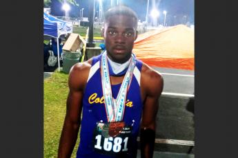 Columbia sprinter James Williamson is pictured with his two medals after placing third in the 100m and fourth in the 200m at the Class 3A state meet on Friday at the University of North Florida’s Hodges Stadium. (COURTESY)