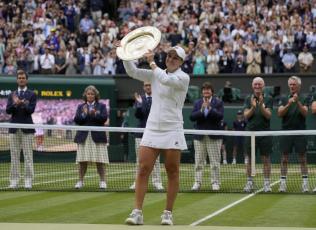 Ashleigh Barty poses with the trophy for the media after defeating Karolina Pliskova to win the Wimbledon women's singles final on Saturday in London. (KIRSTY WIGGLESWORTH/Associated Press)