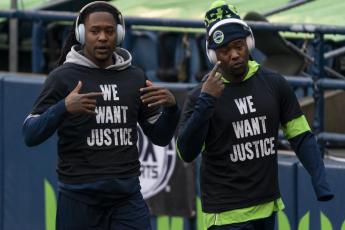 Former Seattle Seahawks cornerback Shaquill Griffin, left, and linebacker Shaquem Griffin are shown during warmups before a game against the Los Angeles Rams on Dec. 27, 2020, in Seattle. The Griffin twins are already talking trash three months before they’re on opposite sidelines for the first time in their lives when the Jacksonville Jaguars host the Miami Dolphins in London this October. (AP FILE)