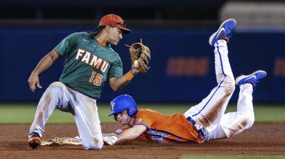 Florida outfielder Brock Edge (18) steals second base, beating the tag by Florida A&M infielder Octavien Moyer (15) during a game on March 4, 2020, in Gainesville. (GARY MCCULLOUGH/Associated Press)