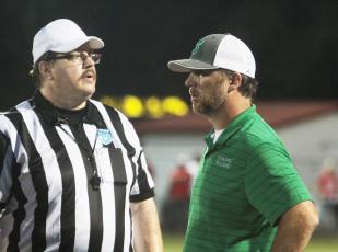 Suwannee head coach Kyler Hall discusses a play with a referee during a game against Dixie County on Aug. 27. (PAUL BUCHANAN/Special to the Reporter)
