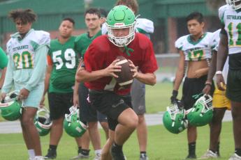 Suwannee quarterback Kodi Lang rolls out to throw during practice on Thursday. (JAMIE WACHTER/Lake City Reporter)