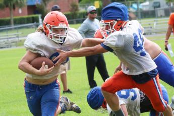 Branford receiver Caden Coker carries the ball up the field during practice on Aug. 13. (JAMIE WACHTER/Lake City Reporter)
