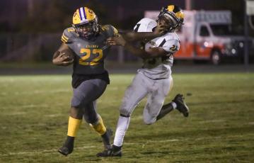 Columbia running back Tony Fulton tries to fight off  a tackle by Englewood linebacker Keeric Merrell on Friday night. (BRENT KUYKENDALL/Lake City Reporter)