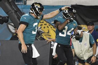 Jacksonville Jaguars quarterback C.J. Beathard (3) congratulates wide receiver Tavon Austin (34) after a reception for a touchdown against the Cleveland Browns during a NFL preseason football game on Aug. 14 in Jacksonville. (PHELAN M. EBENHACK)