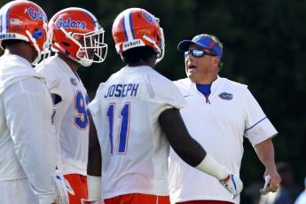 Florida defensive coordinator Todd Grantham works with some of the defense during practice on March 16, 2018, in Gainesville. The 13th-ranked Gators get a chance to show how much they’ve improved. Florida opens the season Saturday night against Florida Atlantic. (BRAD MCCLENNY/Ocala Star-Banner via AP File)