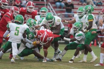 Suwannee safety Trevion Milton tackles Dixie County running back Bryar Mitchell on Aug. 27. (PAUL BUCHANAN/Special to the Reporter)