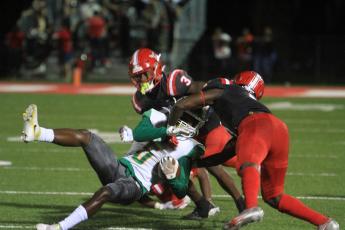 Suwannee receiver/running back Terrell Atkinson gets tackled by Bradford on Friday night. (PAUL BUCHANAN/Special to the Reporter)