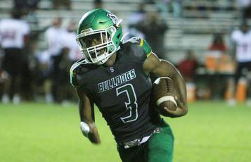 Suwannee running back Malachi Graham runs up the field against Westside on Sept. 3. (PAUL BUCHANAN/Special to the Reporter)