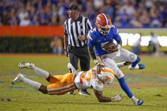 Florida quarterback Emory Jones tries to get past Tennessee defensive back Jaylen McCollough on Sept. 25 in Gainesville. (JOHN RAOUX/Associated Pres)