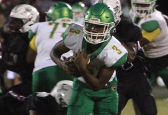 Suwannee running back Malachi Graham runs past a Madison County tackler on Oct. 8. (PAUL BUCHANAN/Special to the Reporter)