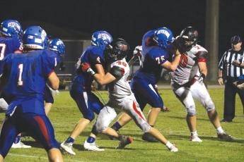 Fort White linebacker Coby Lee tackles Keystone Heights running back Dalton Hollingsworth on Friday night. (MORGAN MCMULLEN/Lake City Reporter)
