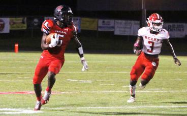 Fort White running back Darren Clark rushes up the field against Dixie County on Oct. 15. (MORGAN MCMULLEN/Lake City Reporter)