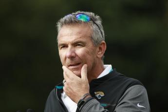 Jacksonville Jaguars head coach Urban Meyer listens to a question during media availability on Friday at Chandlers Cross, England. (IAN WALTON/Associated Press)