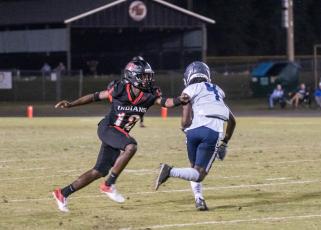 Fort White defensive back Najeeb Smith, bumping a PK Yonge receiver at the line of scrimmage, had two interceptions, including a pick-6. (CHRISTINA FEAGIN/Special to the Reporter)