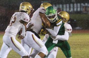 Suwannee receiver Jay Smith is tackled by a host of Florida High defenders on Friday night. (PAUL BUCHANAN/Special to the Reporter)