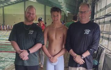 Suwannee swimmer Peyton Slaughter (middle) qualified for the Class 2A State Meet in the 50 freestyle and the 100 backstroke. Slaughter is pictured with assistant coach TJ Vickers (left) and head coach Doug Martin (right). (COURTESY)
