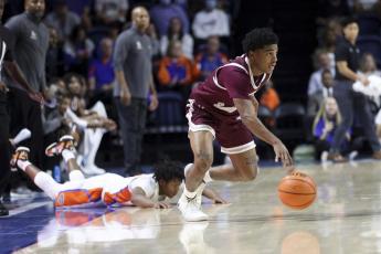 Texas Southern guard PJ Henry dribbles upcourt after coming up with the ball against Florida guard Tyree Appleby during Monday's game in Gainesville. (MATT STAMEY/Associated Press)