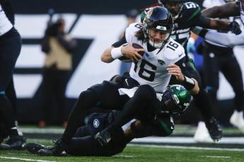 New York Jets cornerback Jason Pinnock tackles Jacksonville Jaguars quarterback Trevor Lawrence during Sunday’s game in East Rutherford, N.J. (JOHN MUNSON/Associated Press)