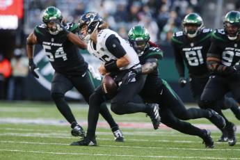 New York Jets linebacker C.J. Mosley strip sacks Jacksonville Jaguars quarterback Trevor Lawrence during Sunday's game in East Rutherford, N.J. (JOHN MUNSON/Associated Press)