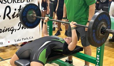 Suwannee’s Emily Gamble bench presses during the Bulldogs’ Power of Christmas invitational. Gamble placed ninth overall in the 169-pound class. (TJ VICKERS/Special to the Reporter)