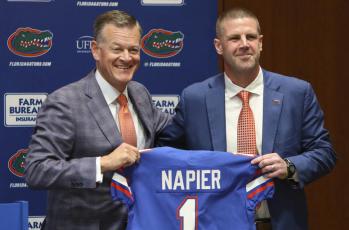 New Florida head football coach Billy Napier, right, and athletic director Scott Stricklin pose for a photo as Napier is introduced during a news conference at Ben Hill Griffin Stadium on Dec. 5 in Gainesville. (BRAD MCCLENNY via AP)