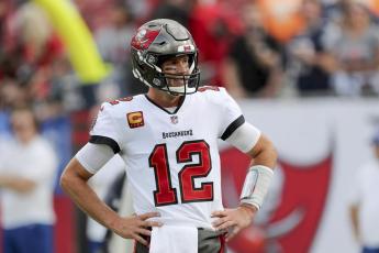 Tampa Bay Buccaneers quarterback Tom Brady looks at the sideline for instructions during a game against the Carolina Panthers on Jan. 9 in Tampa. The Buccaneers play the Philadelphia Eagles in an NFC wild-card game on Sunday. (ALEX MENENDEZ/Associated Press)