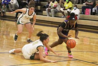Columbia guard Anzarria Jerkins steals the ball away from Fleming Island guard Kennedy Williams. (MORGAN MCMULLEN/Lake City Reporter)