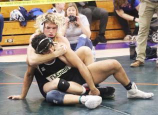 Columbia’s Joseph Rice wrestles with Fleming Island’s Joshua Sandoval during Wednesday’s District 2-2A title match in the 170 class. (JORDAN KROEGER/Lake City Reporter)