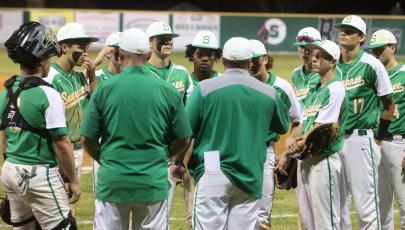 Suwannee’s baseball team huddles up postgame to listen to head coach Justin Bruce after losing to West Nassau 14-6 on Tuesday. (PAUL BUCHANAN/Special to the Reporter)