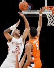 Florida State's Anthony Polite (2) shoots against Syracuse's Frank Anselem (5) during Wednesday's game of the Atlantic Coast Conference men's tournament on Wednesday in New York. (JOHN MINCHILLO/Associated Press)
