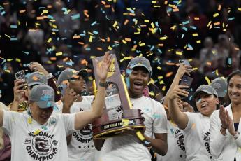 South Carolina's Aliyah Boston holds the trophy after defeating UConn in the NCAA national championship on Sunday in Minneapolis. South Carolina won 64-49 to win the championship. (ERIC GAY/Associated Press)
