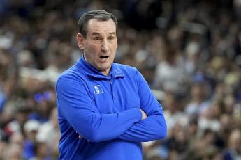 Duke head coach Mike Krzyzewski watches play during Saturday's Final Four contest against North Carolina in New Orleans. (DAVID J. PHILLIP/Associated Press)