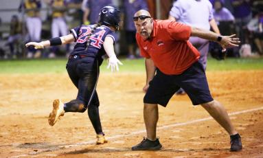 Fort White co-head coach Chad Padgett screams as he congratulates Kadence Compton on her way home on a sixth-inning home run against Union County in the Region 3-1A championship game on Tuesday night. (BRENT KUYKENDALL/Lake City Reporter)