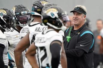 Jacksonville Jaguars head coach Doug Pederson, right, talks with players during practice on May 31 in Jacksonville. (JOHN RAOUX/Associated Press)