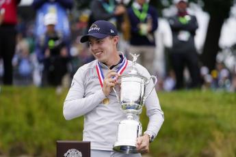 Matthew Fitzpatrick celebrates with the trophy after winning the U.S. Open at The Country Club on Sunday in Brookline, Mass. (JULIO CORTEZ/Associated Press)