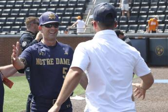 Notre Dame head coach Link Jarrett (left) celebrates after the team defeated Tennessee in an NCAA super regional game on June 12 in Knoxville, Tenn. (RANDY SARTIN/Associated Press)