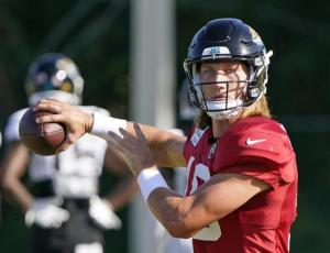 Jacksonville Jaguars quarterback Trevor Lawrence looks for a receiver during practice on July 31 in Jacksonville. (JOHN RAOUX/Associated Press)