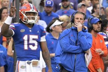Florida coach Billy Napier, front right, and quarterback Anthony Richardson watch from the sideline against Utah last Saturday in Gainesville. (AP Photo/Phelan M. Ebenhack)
