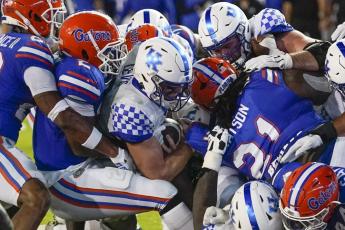 Kentucky quarterback Will Levis (center) scores a touchdown on a 1-yard run against Florida during Saturday’s game in Gainesville. (JOHN RAOUX/Associated Press)
