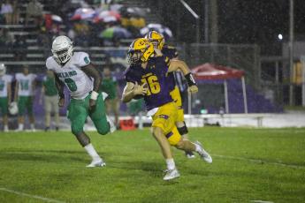 Columbia quarterback Evan Umstead rushes upfield Friday night against DeLand. (BRENT KUYKENDALL/Lake City Reporter)