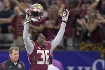Florida State defensive back Shyheim Brown (38) celebrates a dropped punt catch by LSU and recovery by Florida State in the second half of Sunday’s game in New Orleans. Brown would later seal Florida State’s 24-23 victory by blocking an extra point kick attempt by LSU. (MATTHEW HINTON/Associated Press)