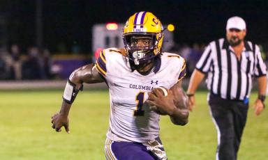 Columbia quarterback Tyler Jefferson scrambles up the field against Union County on Friday. (BRENT KUYKENDALL/Lake City Reporter)