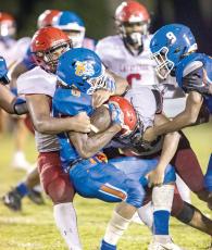 A pair of Lafayette High defenders wrap up a Taylor County ballcarrier last week. (JACK HOWDESHELL/Special to the Reporter)