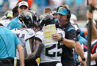 Jacksonville Jaguars running back James Robinson celebrates with head coach Doug Pederson after a touchdown against the Indianapolis Colts on Sept. 18 in Jacksonville. (JOHN RAOUX/Associated Press)