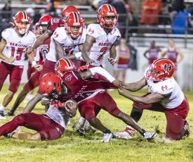 Lafayette running back Kiami McKnight is tackled by a host of Hamilton County defenders on Sept. 16. (JACK HOWDESHELL/Special to the Reporter)