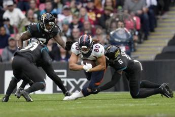 Denver Broncos tight end Greg Dulcich dives for yardage during Sunday's game against the Jacksonville Jaguars at Wembley Stadium in London. (KIRSTY WIGGLESWORTH/Associated Press)