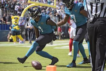 Jacksonville Jaguars running back Travis Etienne Jr. (1) celebrates his touchdown run against the New York Giants with wide receiver Zay Jones (7) on Oct. 23 in Jacksonville. (PHELAN M. EBENHACK/Associated Press)