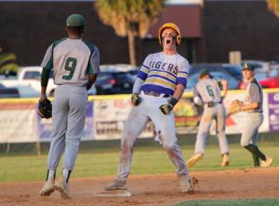 Columbia’s Hayden Gustavson celebrates after reaching second base against Lincoln in last season’s regional final. (BRENT KUYKENDALL/Lake City Reporter)